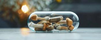 Psilocybin mushrooms and microdose capsule are laying in glass container on table | Image Credit: HISTOCK | stock.adobe.com