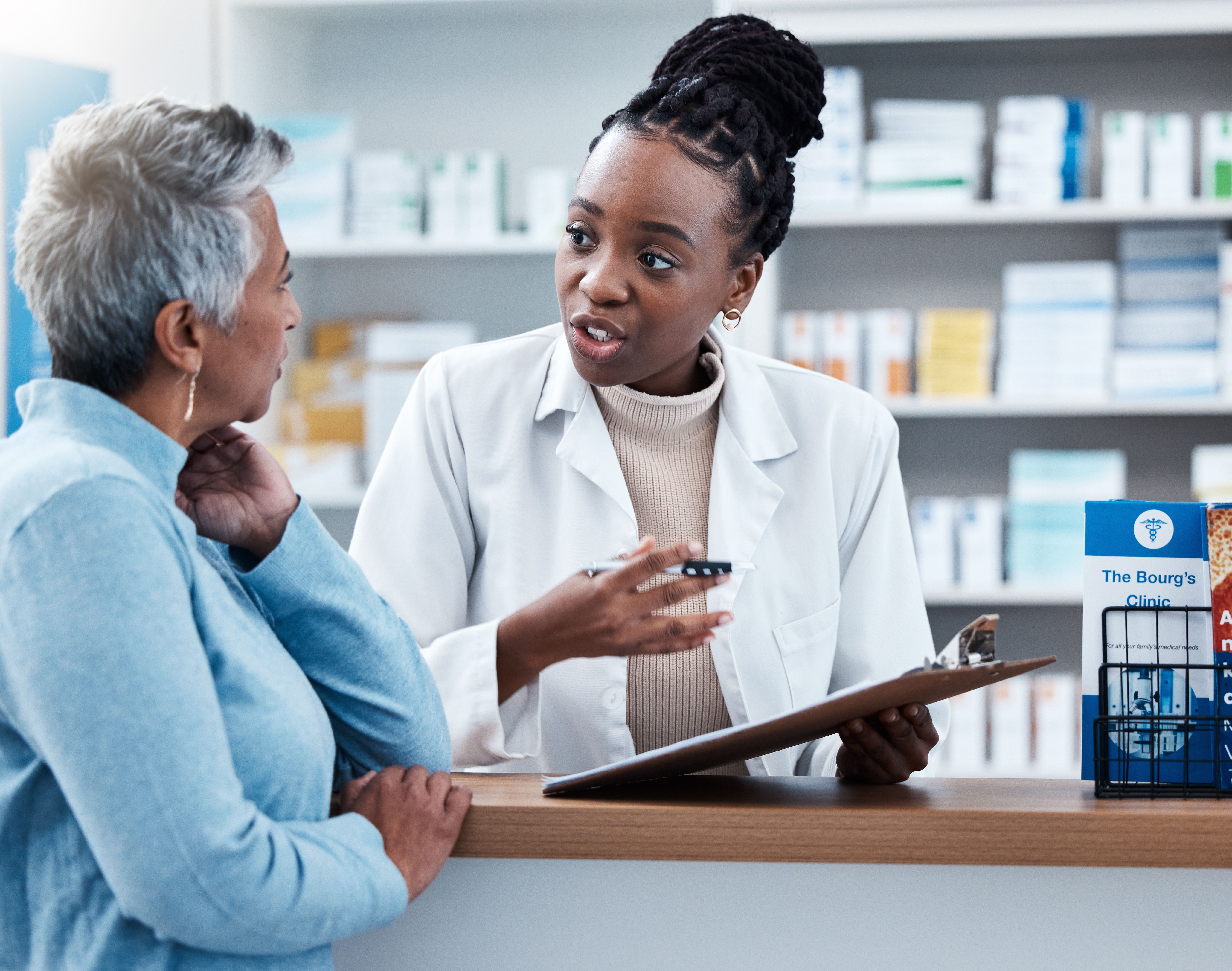 Pharmacist telling a female patient about her treatment