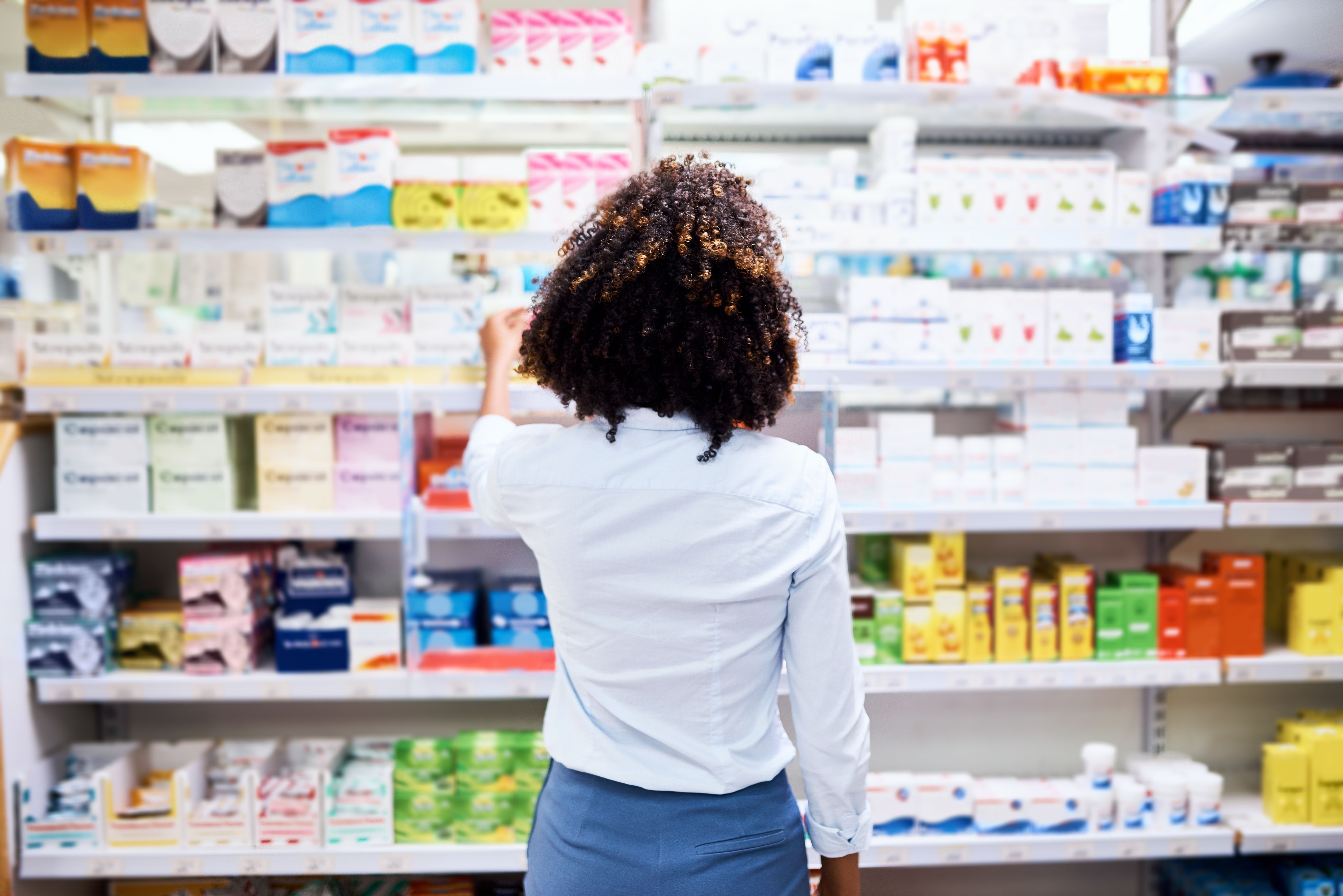 Back, pharmacy and medication with a woman customer buying medicine from a shelf in a dispensary. Healthcare, medical or treatment with a female consumer searching for a health product in a drugstor - Image credit: Arnell Koegelenberg/peopleimages.com | stock.adobe.com Back, pharmacy and medication with a woman customer buying medicine from a shelf in a dispensary. Healthcare, medical or treatment with a female consumer searching for a health product in a drugstor - Image credit: Arnell Koegelenberg/peopleimages.com | stock.adobe.com