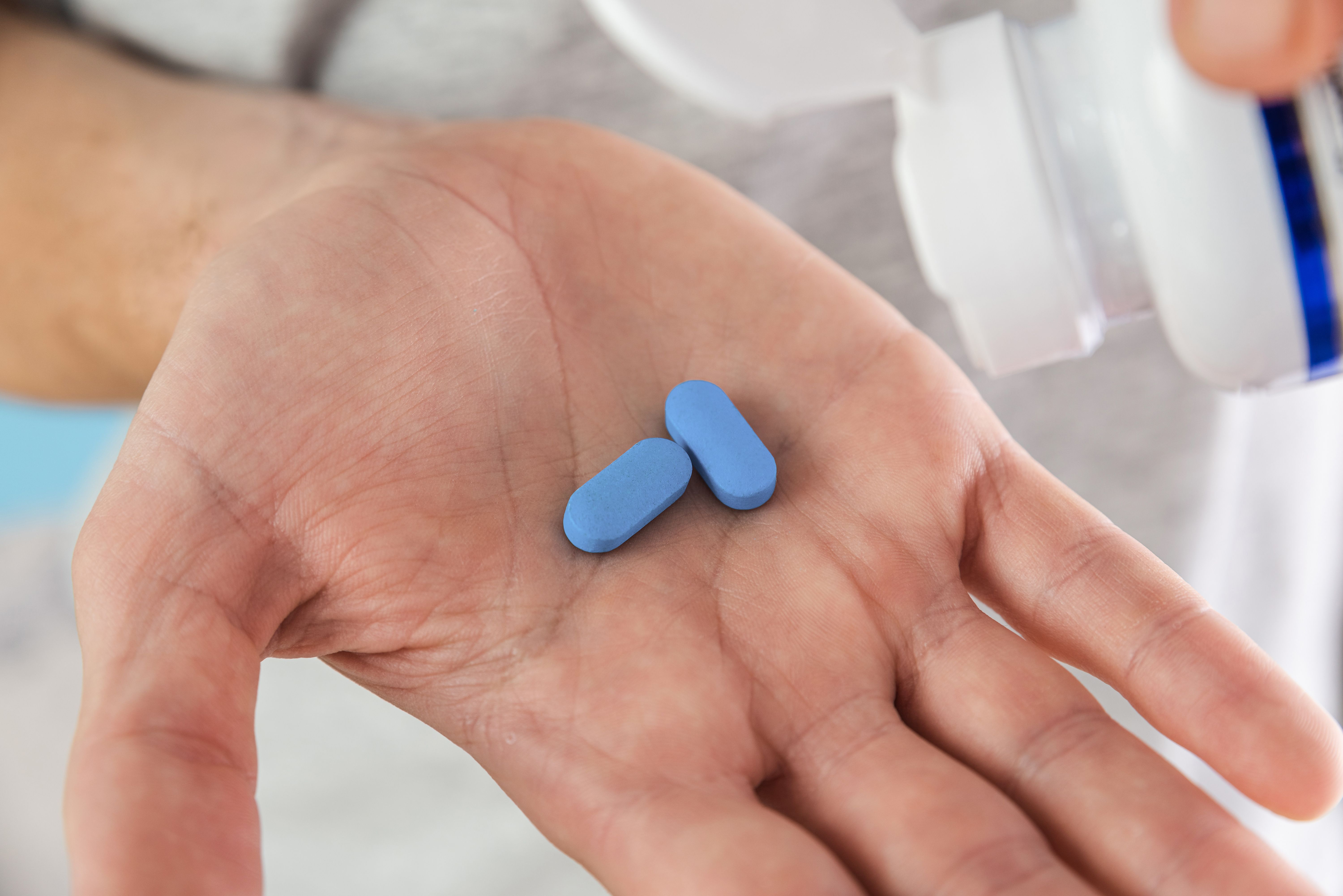 Man holding oral PrEP