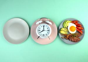 Intermittent fasting concept with empty colorful plates. Time to lose weight , eating control or time to diet concept.