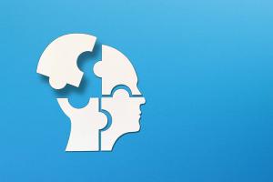 Mental health concept. Human head puzzle pieces on blue background.