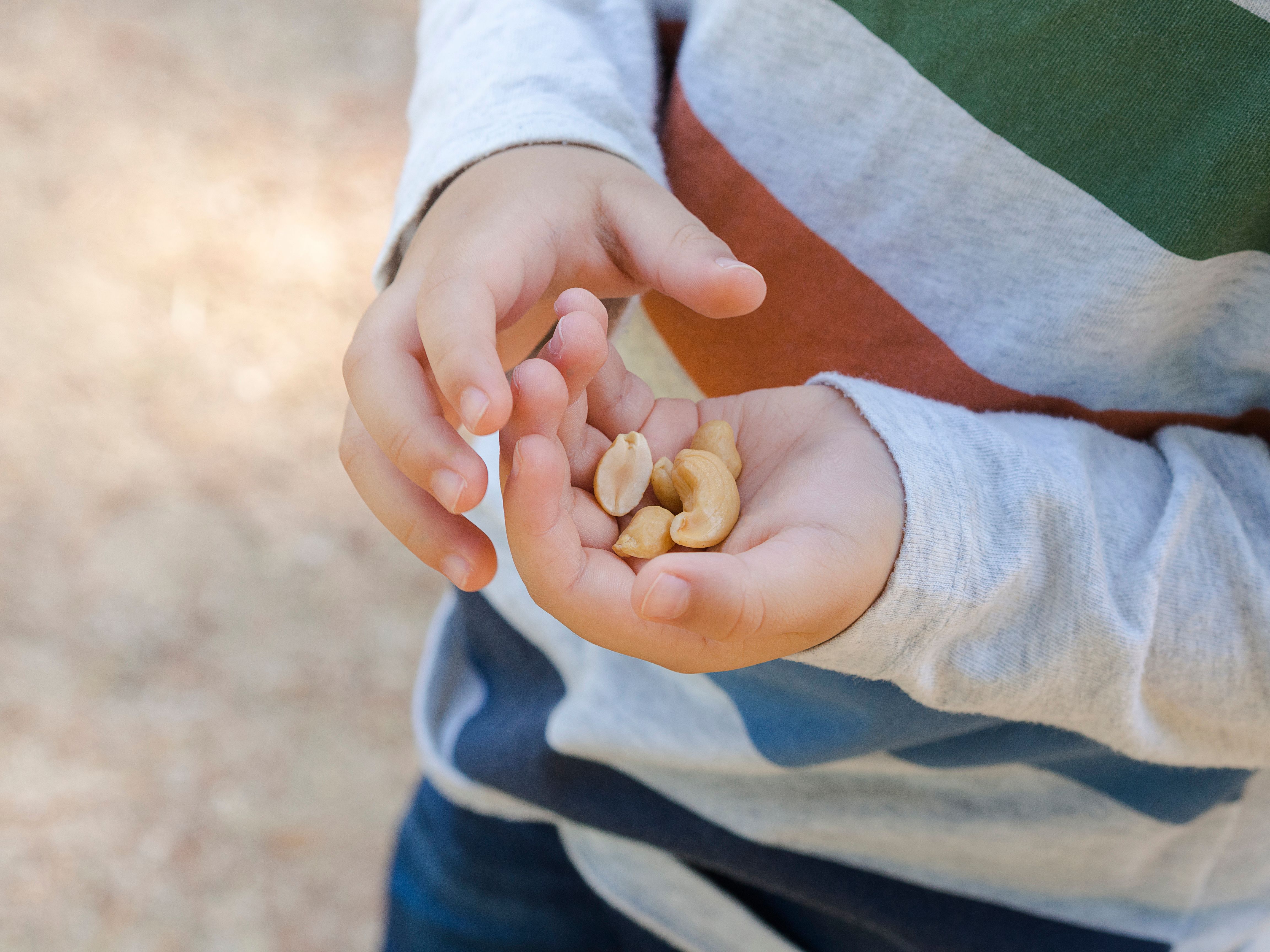 Young child holding peanuts -- Image credit: MadameMoustache | stock.adobe.com