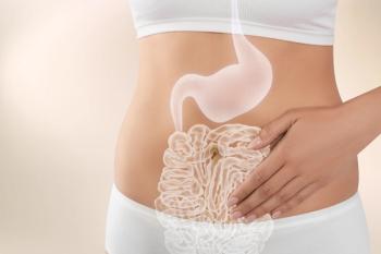 Woman with healthy digestive system on light background, closeup. Illustration of gastrointestinal tract - Image credit: New Africa | stock.adobe.com