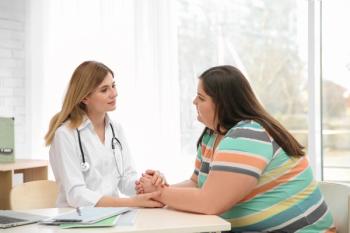 Female doctor consulting overweight woman in clinic