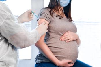 Pregnant Vaccination. Pregnant Woman In Face Mask Getting Vaccinated in Clinic. Doctor Giving Corona Virus Vaccine Injection Patient. Covid-19 Flu Protection. Selective focus. Syringe close up. | Image Credit: Marina Demidiuk | stock.adobe.com