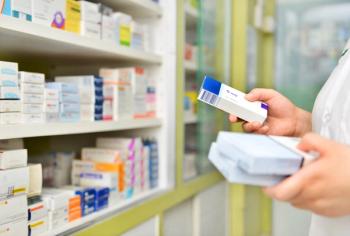 Pharmacist holding medicine box in pharmacy drugstore. | Image Credit: I Viewfinder - stock.adobe.com