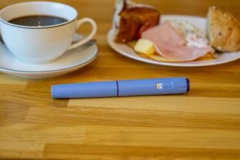 Diabetes and weight loss medication injection pen Ozempic with breakfast food background, GLP-1 therapy concept for obesity management and metabolic health