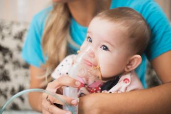 Mom makes inhalation of the child, holding hands - Image credit: komokvm | stock.adobe.com