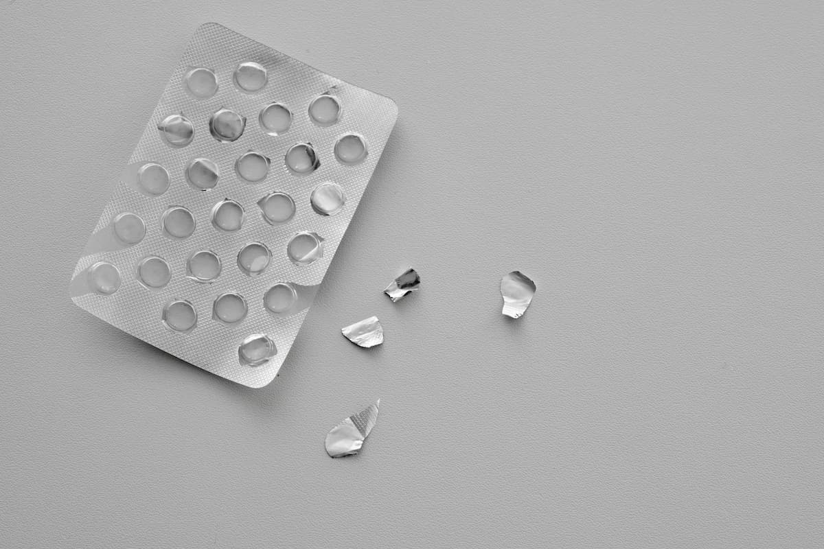 Pills blister pack on a white background. Top view food supplements empty packaging. Medicine shortage concept. Running out of drugs.