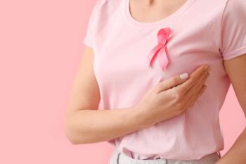 Woman with pink ribbon for breast cancer awareness -- Image credit: Pixel-Shot | stock.adobe.com