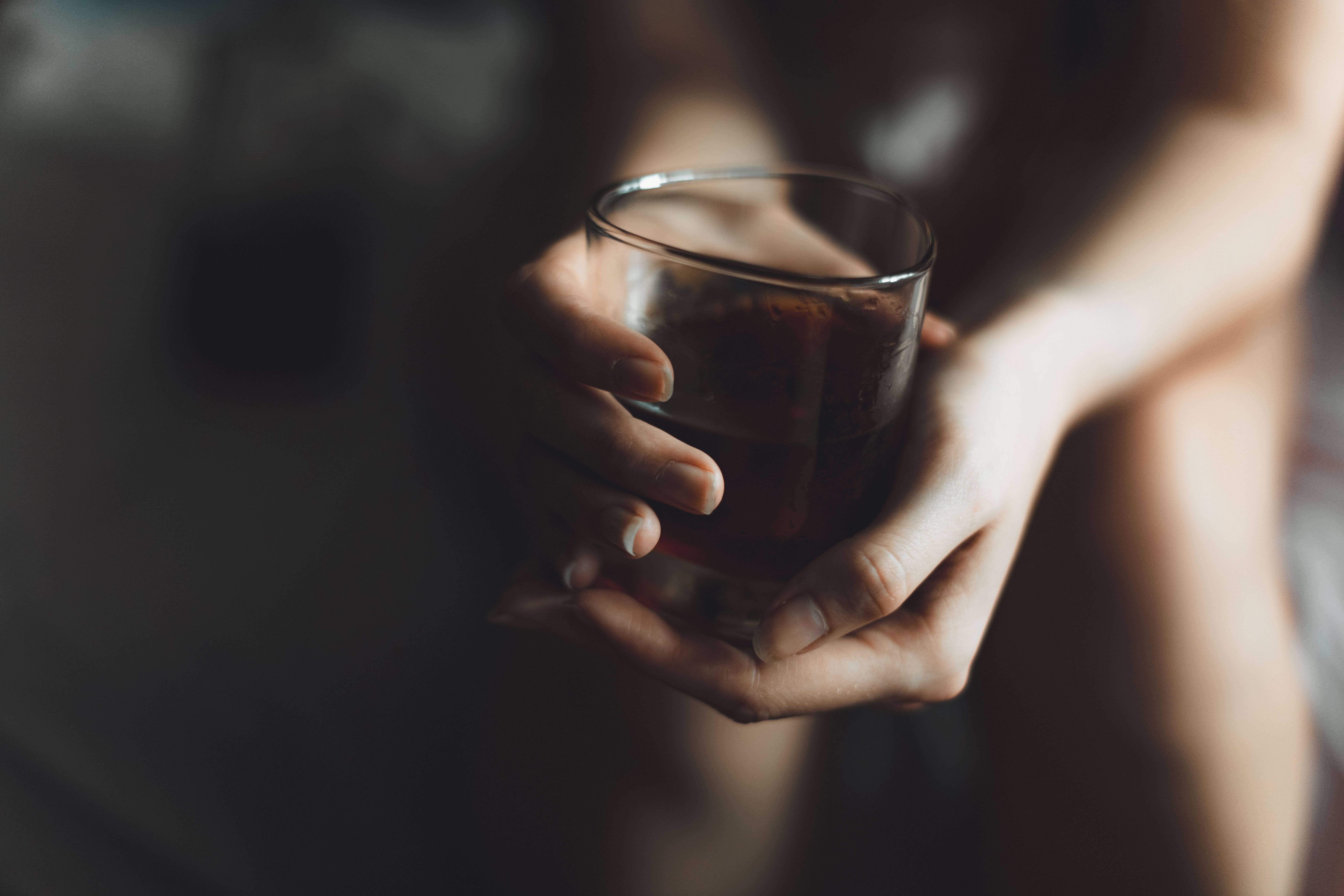 woman's hand with alcohol drink in glass with copy space - Image credit: Danil Nikonov | stock.adobe.com