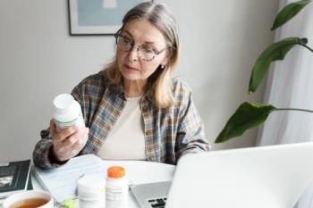 woman holding bottle of dietary supplement and reading label with instruction, ingredients or brand name carefully before ordering vitamins online using laptop and web application | Image Credit: shurkin_son | adobe.stock.com