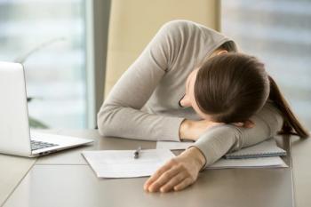 Woman with narcolepsy falling asleep at desk -- Image credit: fizkes | stock.adobe.com