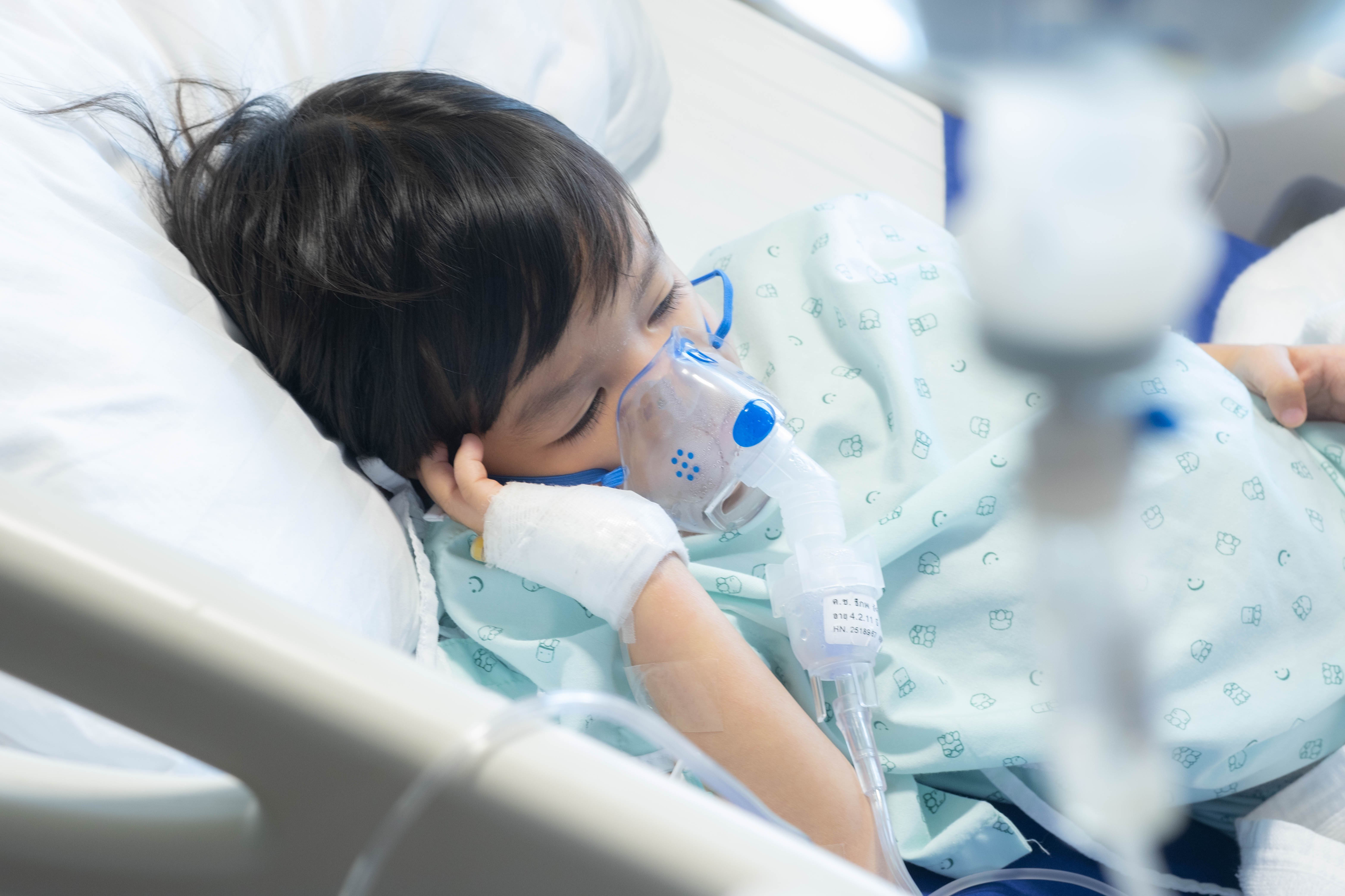 Toddler boy has Cold or Flu or influenza or asthma or pneumonia disease and need nebulizations,Sick boy rest on patient bed in hospital and has inhalation therapy by the mask of inhaler.Sick - Image credit: Bonn | stock.adobe.com
