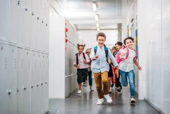 Pupils running through school corridor - Image credit: LIGHTFIELD STUDIOS | stock.adobe.com
