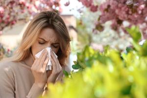 Woman suffering from seasonal pollen allergy outdoors - Image credit: New Africa | stock.adobe.com