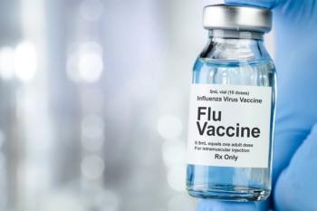 Healthcare concept with a hand in blue medical gloves holding Flu, Influenza, vaccine vial - Image credit: Leigh Prather | stock.adobe.com