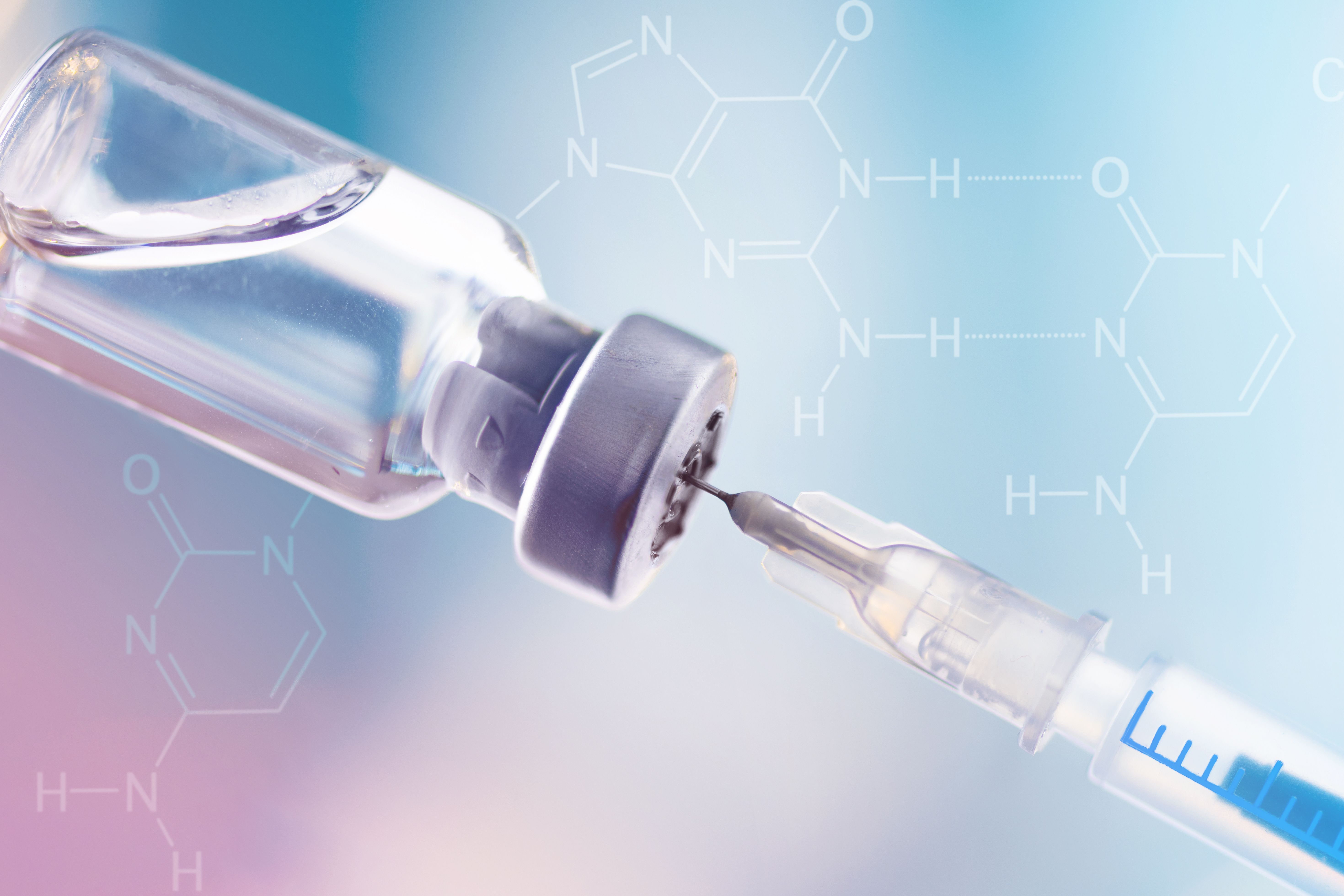 Glass vial and syringe with injection over blue background. Vaccination or beauty therapy concept. | Image Credit: Inna Dodor - stock.adobe.com