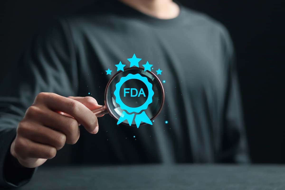 FDA Approved Food and Drug Administration concept. Person with FDA icon on virtual screen for Health product standards control system.
