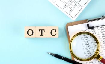OTC word on wooden cubes on blue background with chart and keyboard | Image credit: Iryna- stock.adobe.com