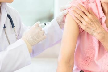 Close up doctor with syringe doing injection vaccine,flu,influenza in the shoulder of woman, nurse injecting,vaccinating patient,vaccination,medicine,health care concept