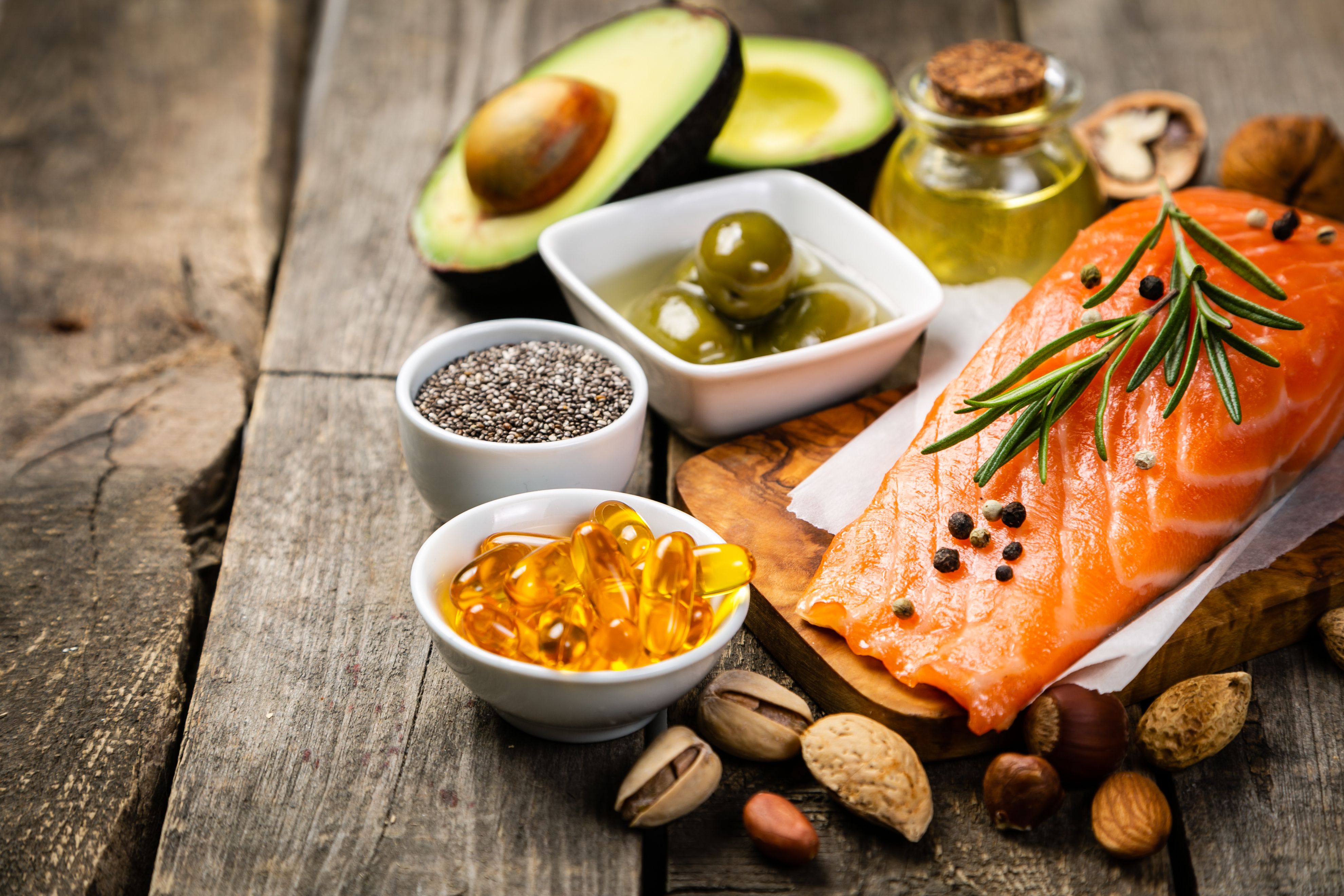 Selection of healthy unsaturated fats, omega 3 - fish, avocado, olives, nuts and seeds - Image credit: anaumenko | stock.adobe.com