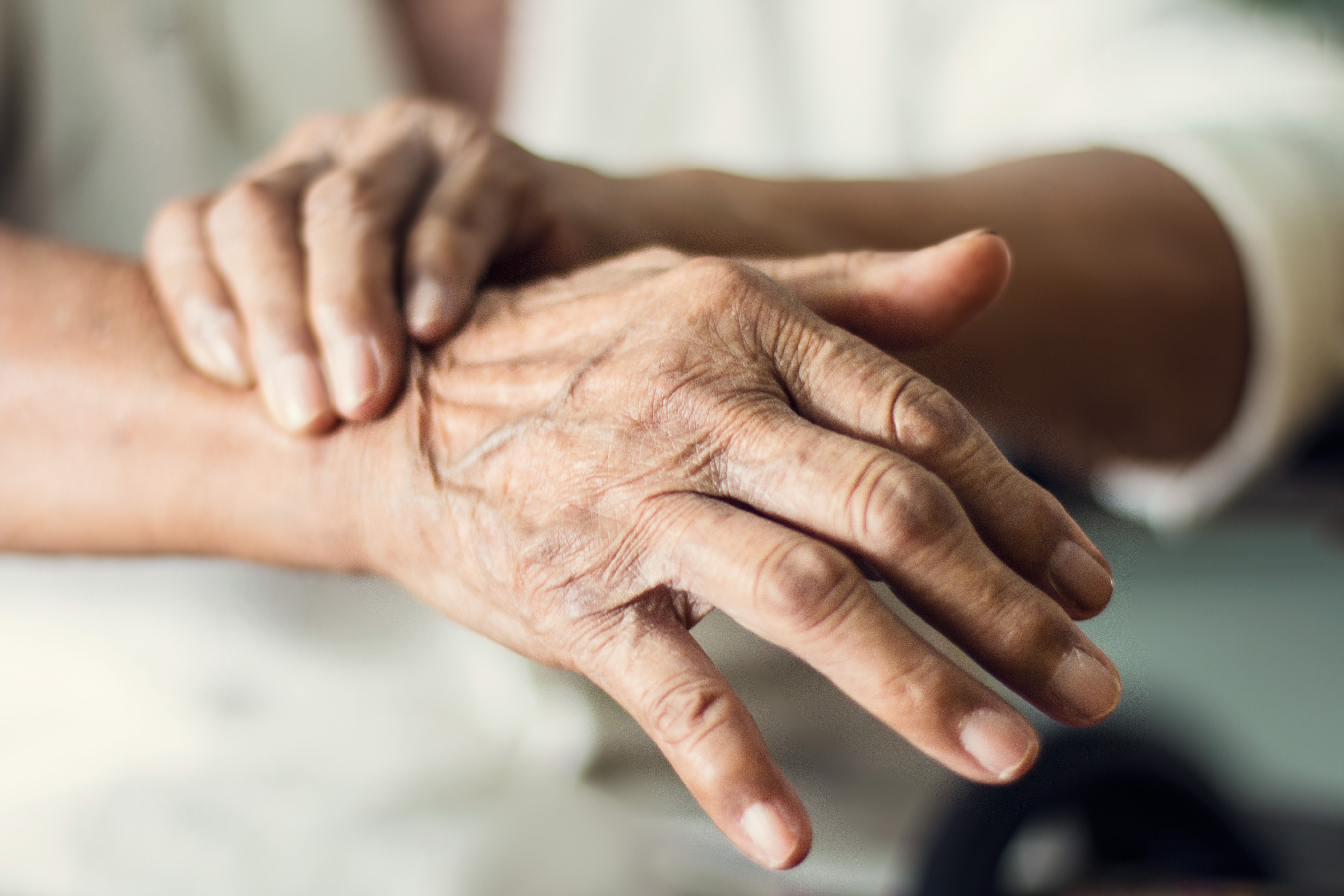 Close-up of elder man's hands with Parkinson disease, multiple system atrophy | mage Credit: © ipopba - stock.adobe.com