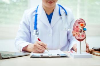 Health care professional with model of kidney showing chronic kidney disease (CKD) -- Image credit: M+Isolation+Photo | stock.adobe.com