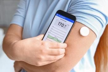 Woman with glucose sensor using mobile phone for measuring of blood sugar level, closeup - Image credit: Pixel-Shot | stock.adobe.com