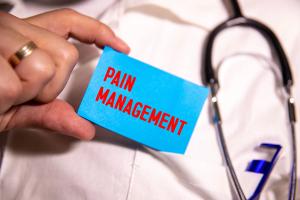 Caucasian doctor massaging patient hand. Pain management | Image Credit: Uladzislau | stock.adobe.com