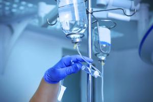 Health care professional setting up infusion -- Image credit: Africa Studio | stock.adobe.com