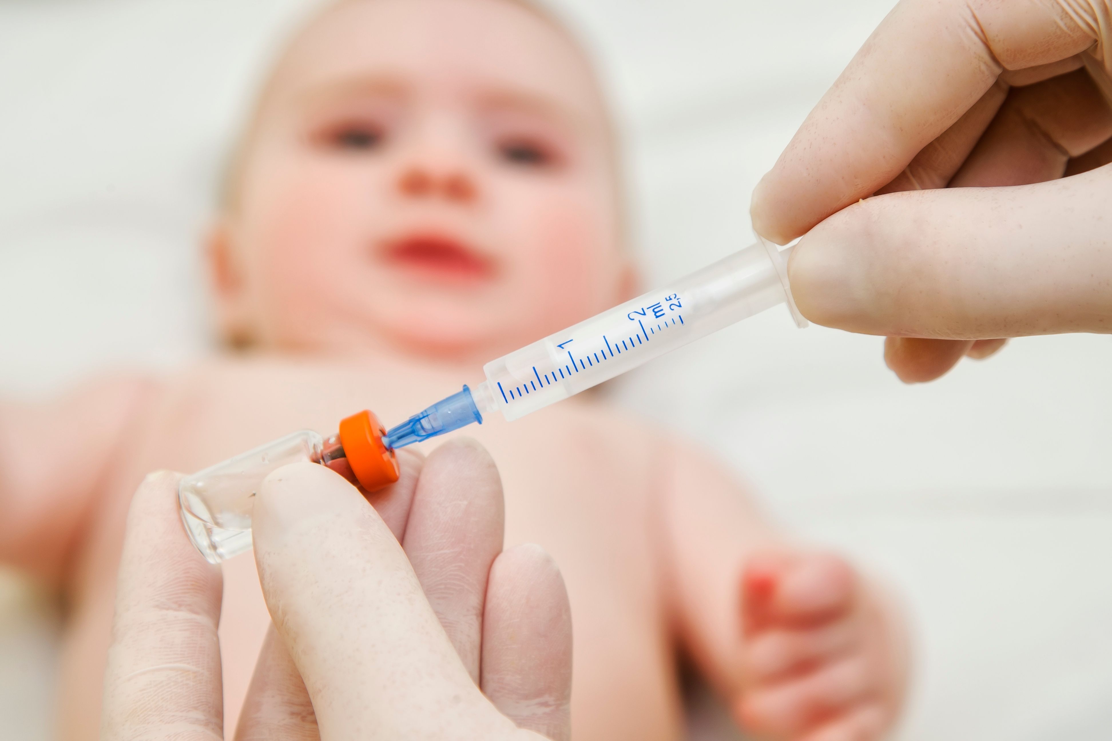 Doctor holding syringe to vaccinate baby | Image Credit: © sonar512 - stock.adobe.com