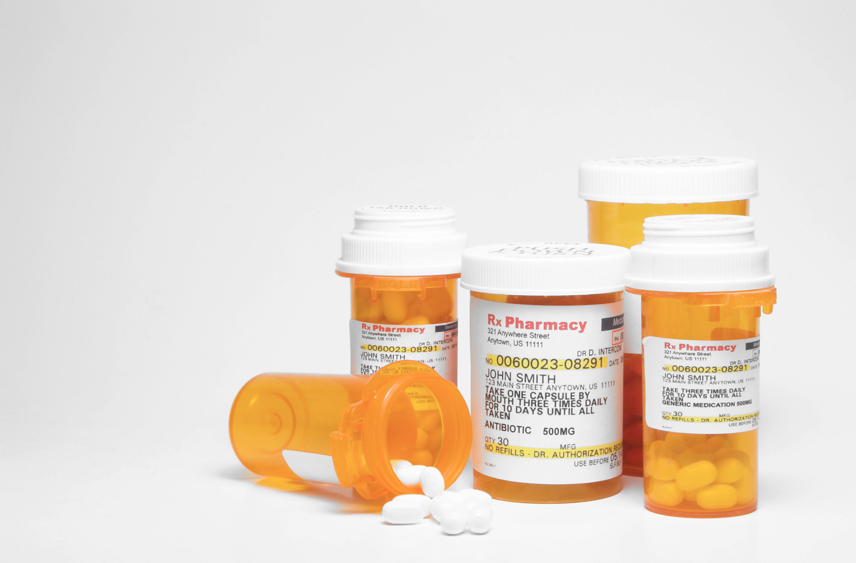 Prescription pills in plastic medicine bottles.