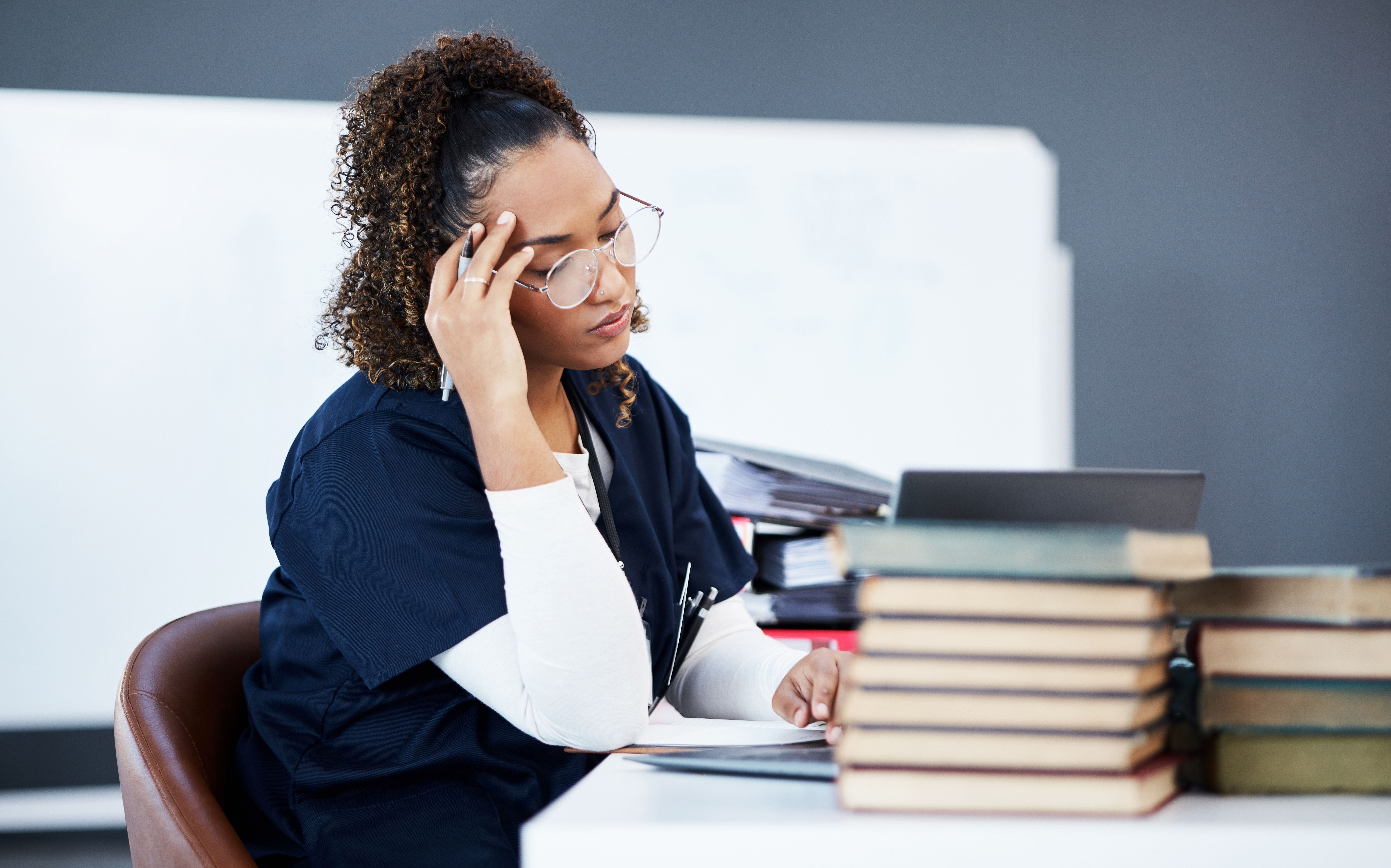 Tired pharmacy student -- Image credit: Rene La/peopleimages.com | stock.adobe.com
