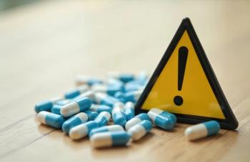 Warning sign surrounded by pills | Image Credit: © Vadym - stock.adobe.com