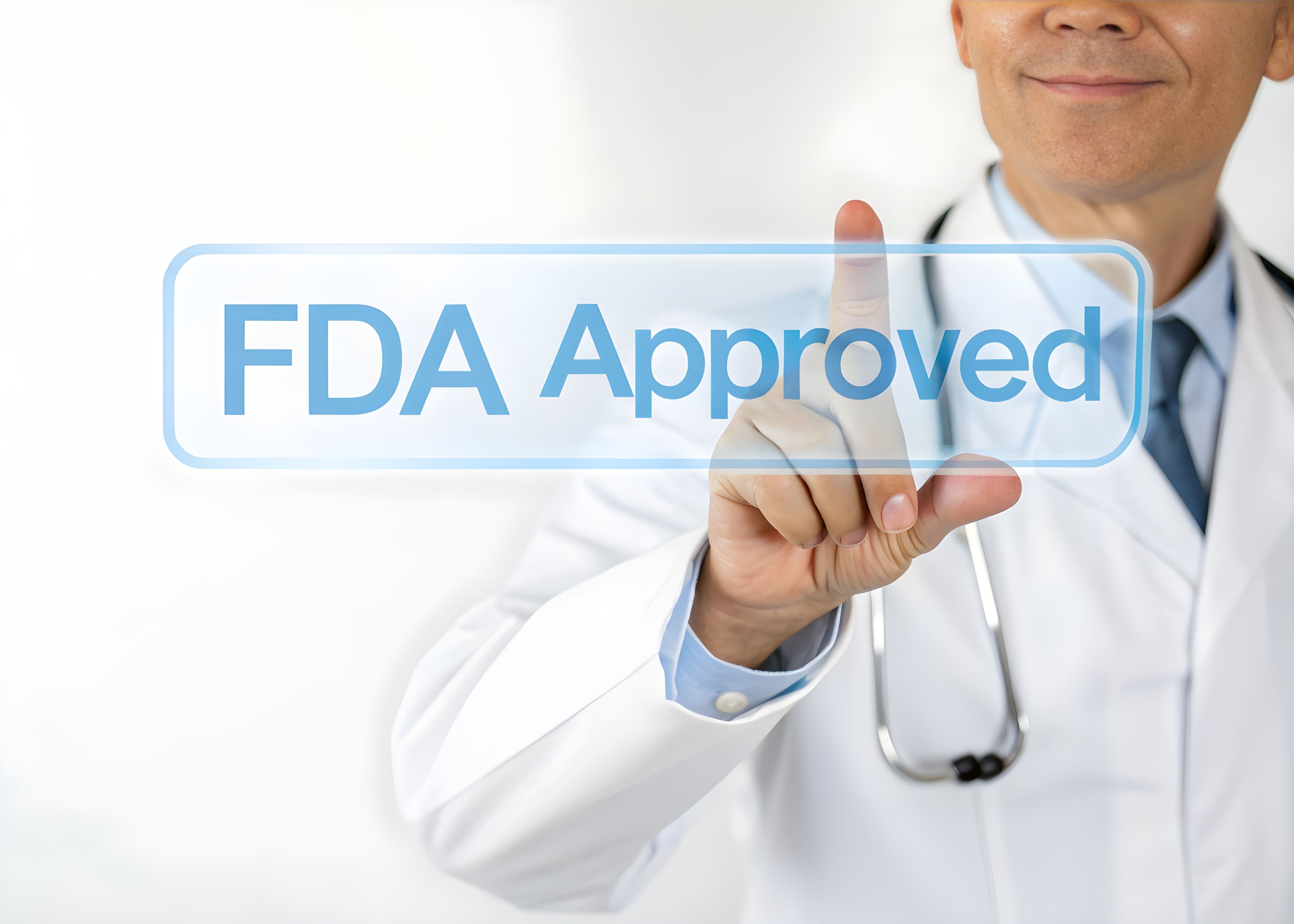 Photo of a doctor in a white coat touching a transparent digital screen with the text ‘FDA Approved’ glowing in blue, representing medical certification and trust. | Image Credit: Muhammad | stock.adobe.com