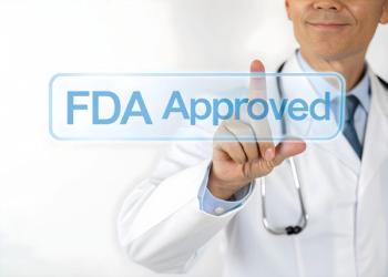 Photo of a doctor in a white coat touching a transparent digital screen with the text ‘FDA Approved’ glowing in blue, representing medical certification and trust. | Image Credit: Muhammad | stock.adobe.com