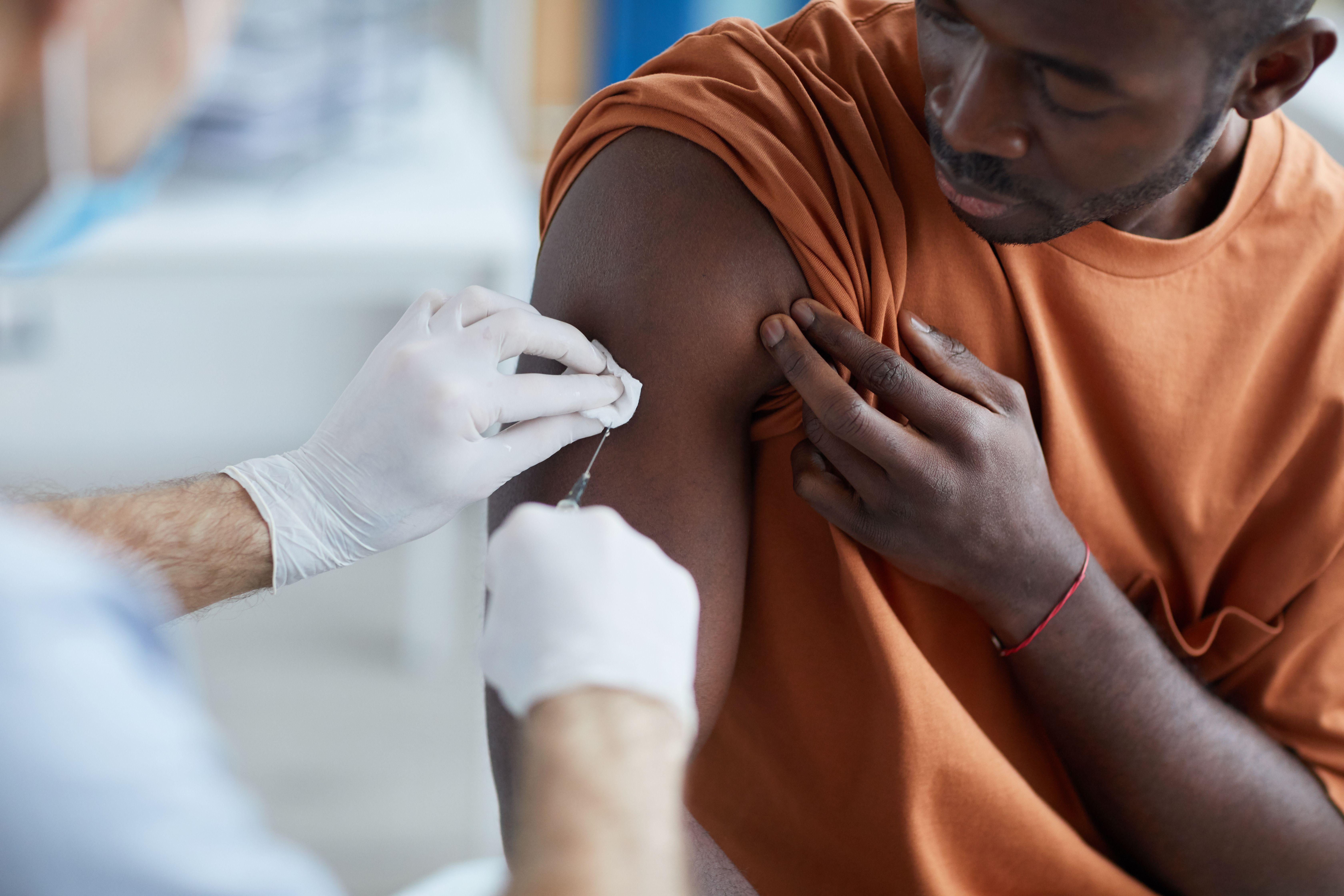 Close up of unrecognizable male nurse injecting vaccine in shoulder of man during covid vaccination in clinic or hospital, copy space | Image Credit: Seventyfour | stock.adobe.com