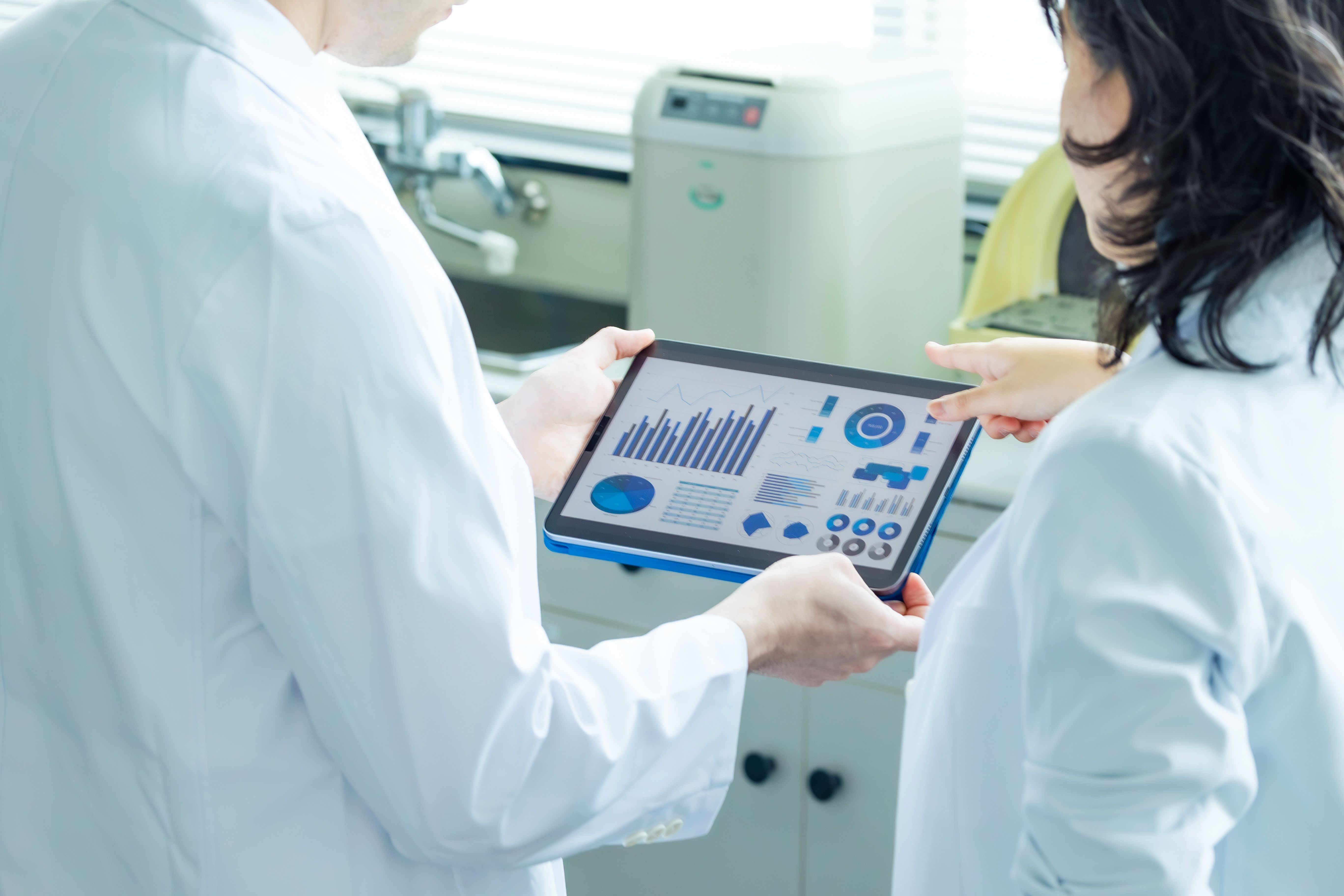 Group of researchers looking at tablet data.