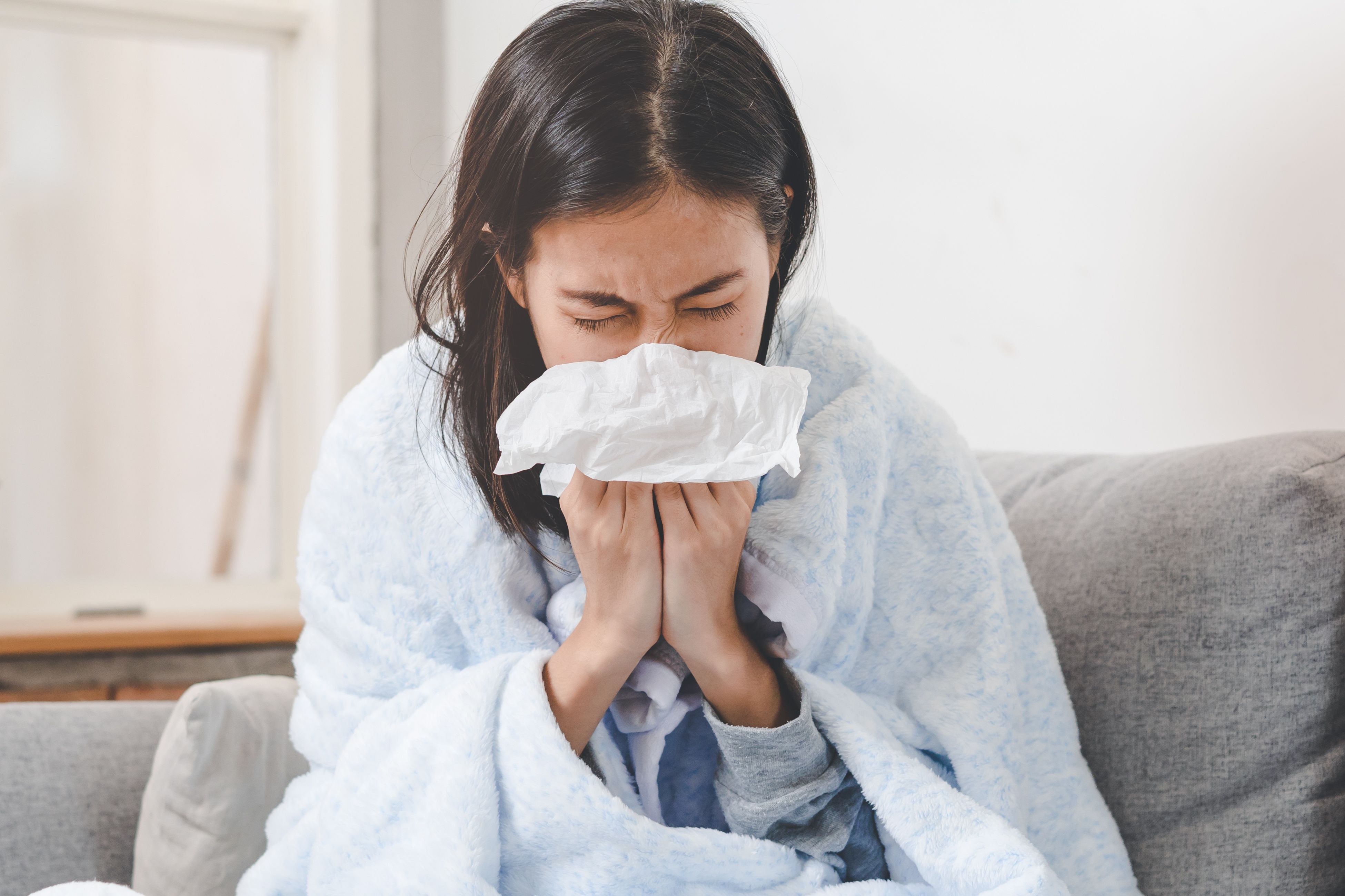 Woman blowing nose | Image Credit: © Pormezz - stock.adobe.com