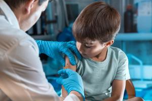 pediatrician vaccinating little boy in the pediatric clinic / doctor holding syringe subcutaneous vaccine for child in the medical office - Image credit: angellodeco | stock.adobe.com