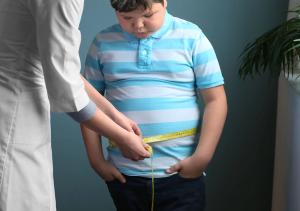 Doctor measuring overweight boy in clinic - Image credit: Africa Studio | stock.adobe.com