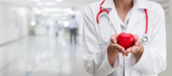 Doctor holding a red heart at hospital office. Medical health care and doctor staff service concept - Image credit: Summit Art Creations | stock.adobe.com