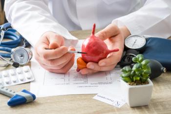 At doctors appointment physician shows to patient shape of urine bladder with focus on hand with organ. Scene explaining patient causes and localization of diseases of bladder and the urinary system - Image credit: shidlovski | stock.adobe.com