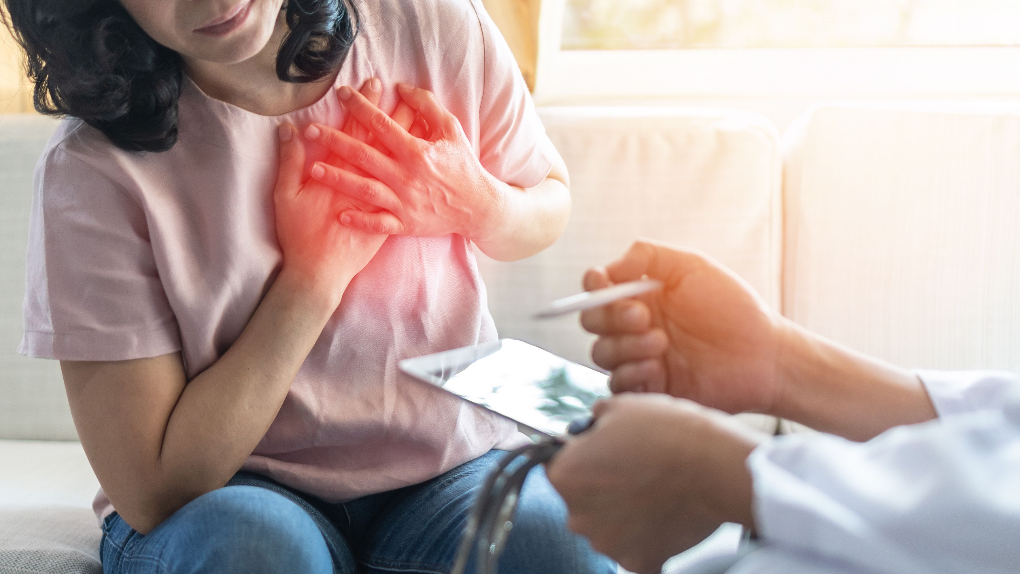 Chest pain illness causing heart attck and stroke risk in woman patient with doctor examing and diagnosing patient health in hospital clinic | Image Credit: Chinnapong | stock.adobe.com