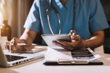 Health care professional using technology -- Image credit: Nuttapong punna | stock.adobe.com