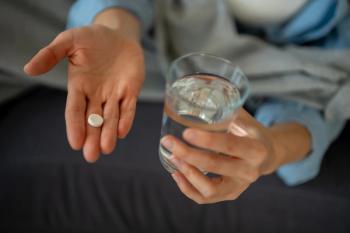 Person taking oral medicine with fresh water glass | Image Credit: © Jelena - stock.adobe.com