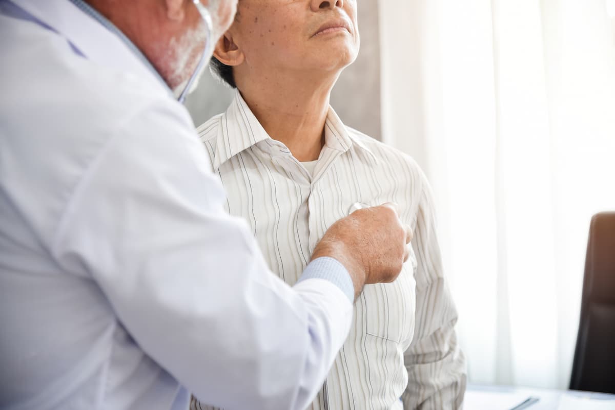 Senior doctor is examining a patient.