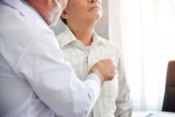 Senior doctor is examining a patient.